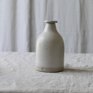 white flecked stoneware bottle